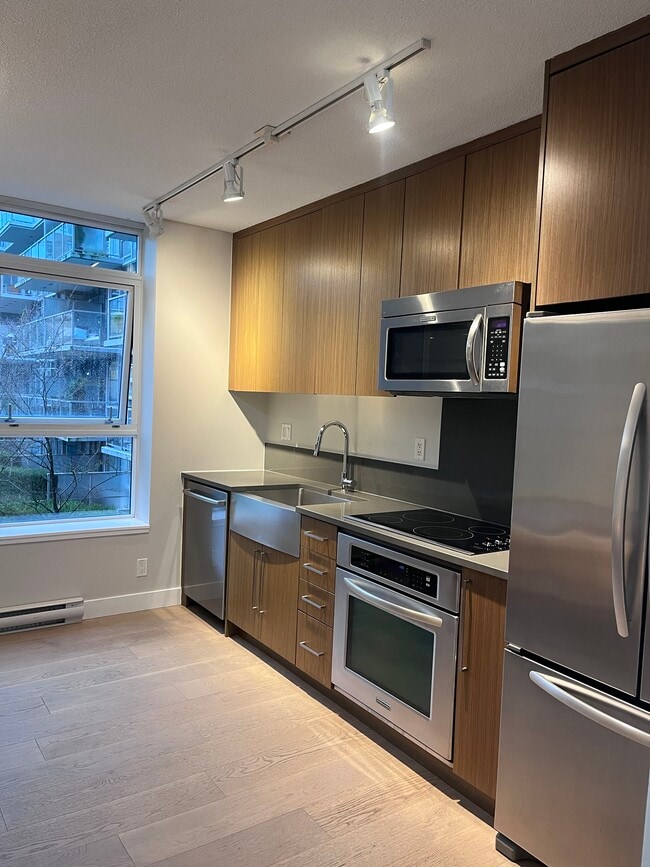 Kitchen with full size appliances (new stove) - 250 6th Av E Unit 255