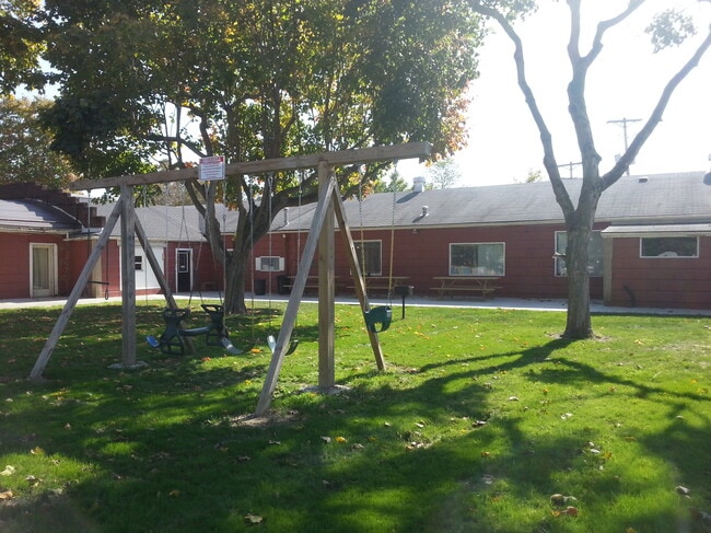 Courtyard with Swing Set, Picnic Tables, and Grills