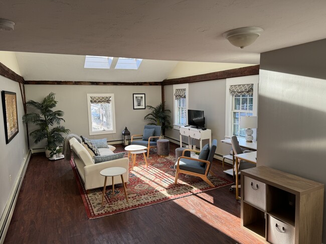 Livingroom with skylights - 67 Warren St Unit Carriage House Furnished Apartment