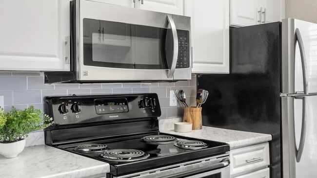 Luxurious stainless-steel appliances paired with stunning subway tile backsplash in every remodeled kitchen.