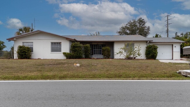 Building Photo - Recently painted 4BR/3BA home with tile floors throughout, fenced yard, detached garage, and prim...