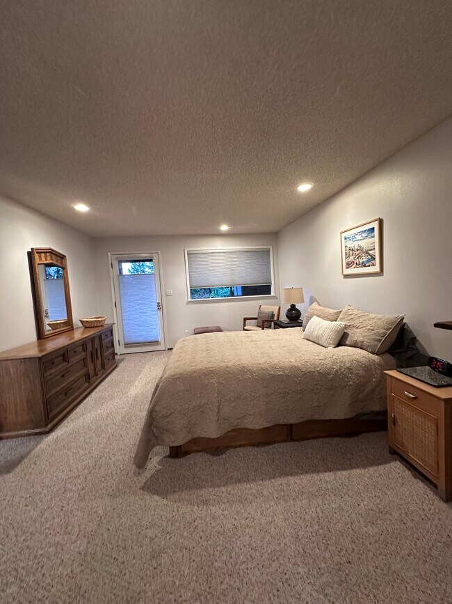 Large bedroom with private patio. - 4439 54th Ave SW