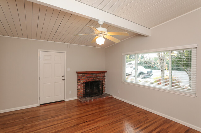 Living room with large picture window & fireplace - 3321 Alma St Apartments Unit 3321