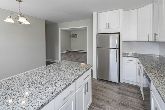 Newly renovated kitchen with white cabinets and granite countertops - Troy Hills Village