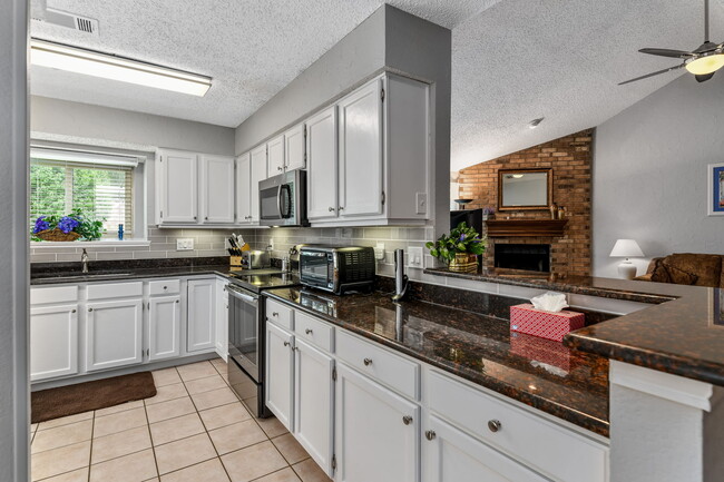 Bright & clean kitchen fully provisioned for home cooking - 7312 Augusta Cir Homes