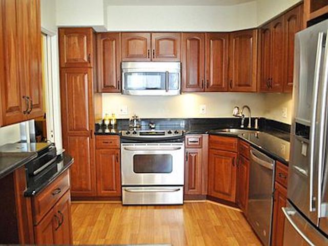 Kitchen with granite counters and stainless steel appliances - 1045 31st St NW Unit 301