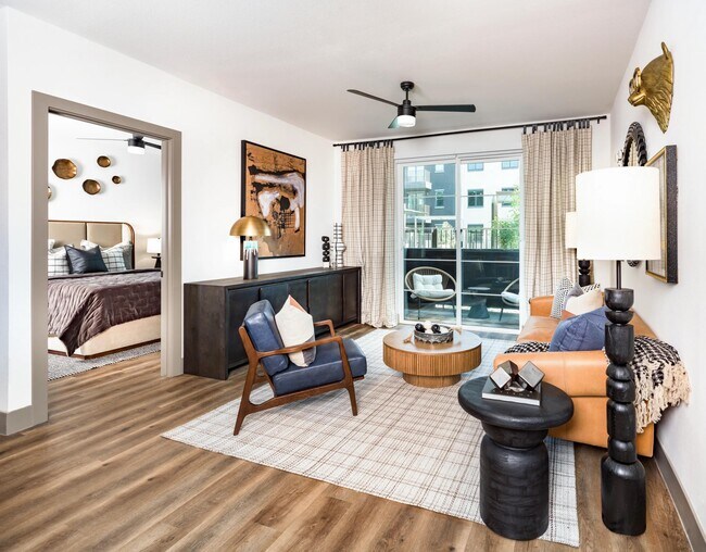 Open-concept living areas feature oversized windows, wood-style plank flooring, and seamless access to private outdoor spaces.