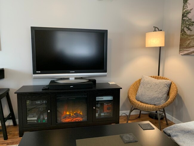 Chair in corner next to fireplace/TV stand - 1433 E. Edgemont Avenue Unit Guest House