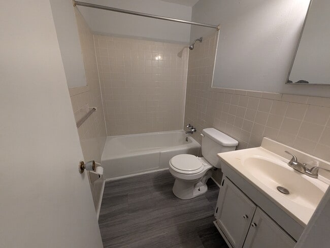 Full bathroom complete with shower/tub combo, vanity, and neutral finishes.
