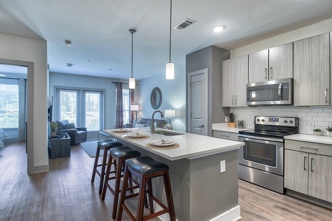 Gourmet kitchens with quartz countertops and modern cabinets with under cabinet lighting - Windsor Parkview Apartments