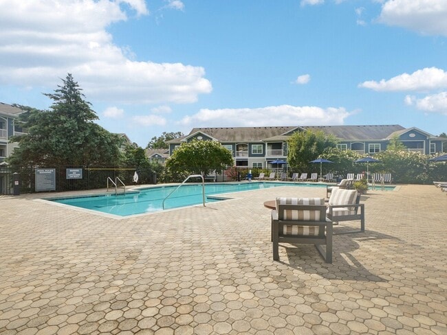 Resort-style swimming pool and outdoor resident lounge spaces at Village at Broadstone Station in Apex, North Carolina
