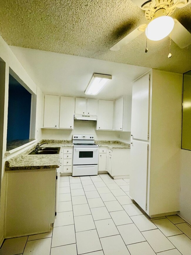 Photo - Charming 2-Bedroom, 1.75-Bathroom Unit with Garage, Patio & Community Amenities! Unit 208