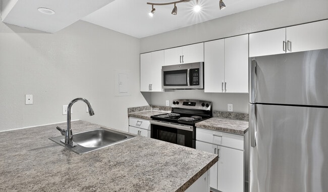 Cook, dine, and gather in a stylish kitchen space. - Skyview Apartment Homes