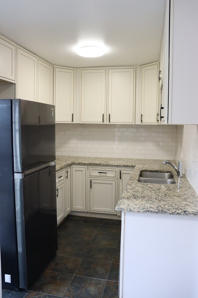 Fridge, freezer, sink & dishwasher. Lots of space for food & kitchen equipment. - 6396 E Mississippi Ave Unit 6396 E Mississippi Ave