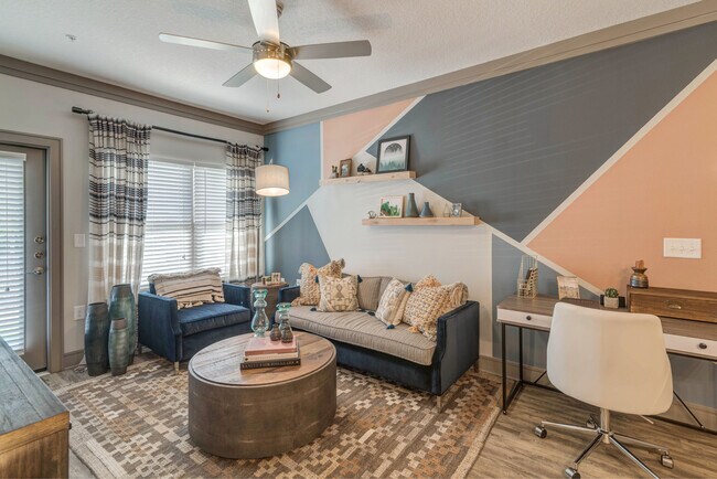 Living room with hard-surface flooring and ceiling fan