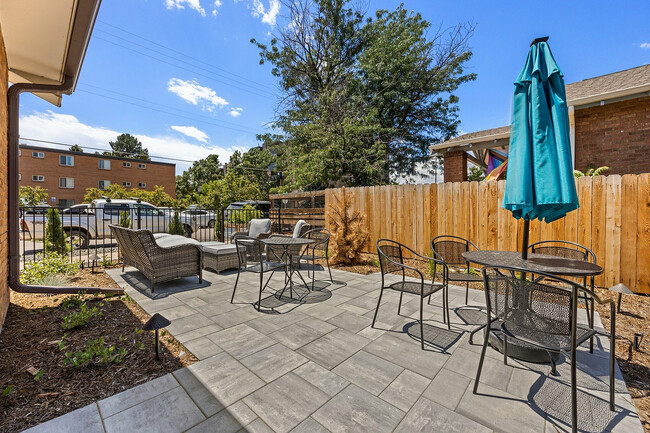 Relax and unwind in this cozy outdoor patio, perfect for entertaining guests. - Charmel Apartments