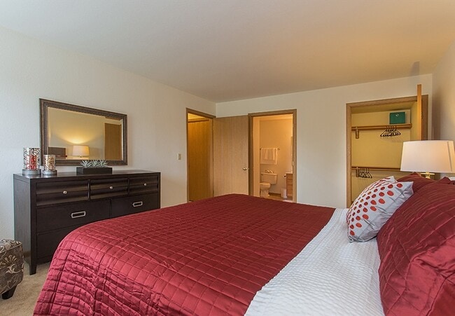 Primary Bedroom facing Ensuite Bathroom & Large Closet