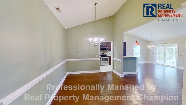 Photo - Beautiful home boasts open floorplan, screened porch, and spacious fenced yard