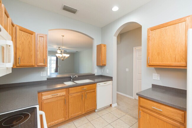 Plenty of cabinetry in kitchen with view into great room - 18135 Nassau Point Dr