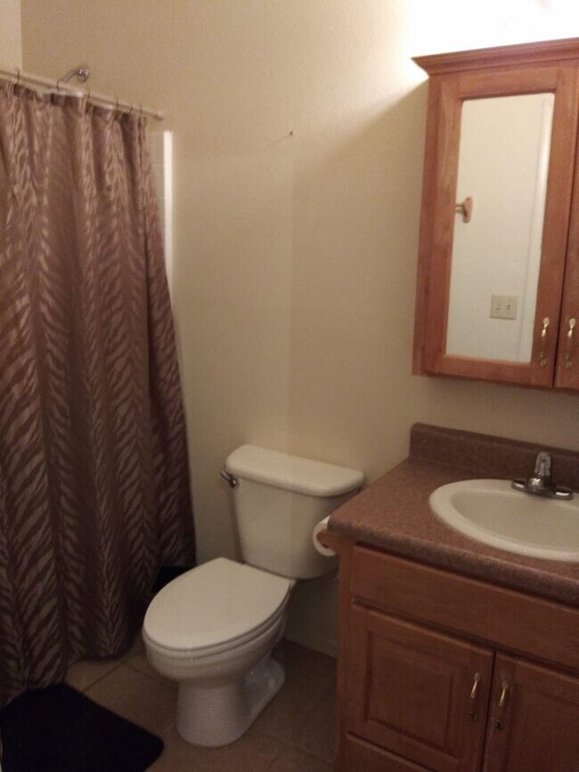 Photo - Modern town home with AC. 3/2. Covered, off-street parking, easy care yard.  Ample kitchen. Lamin...