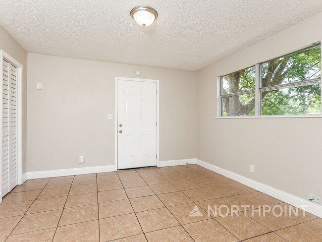 Photo - 3 BR/1BA | Newly Renovated Single Family Home | Screened in Patio and carpot | Huge backyard!
