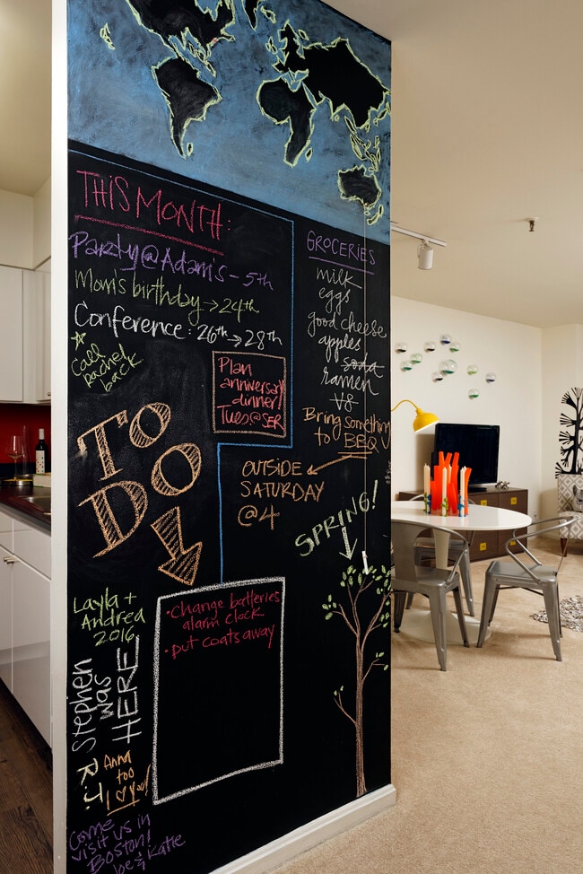 Classic Package living area with carpet and chalkboard accent wall