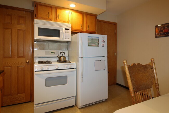 Refrigerator with automatic ice maker, gas range and OTR Microwave