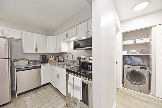 Kitchen with granite counters, stainless appliances, and modern cabinetry - Nora