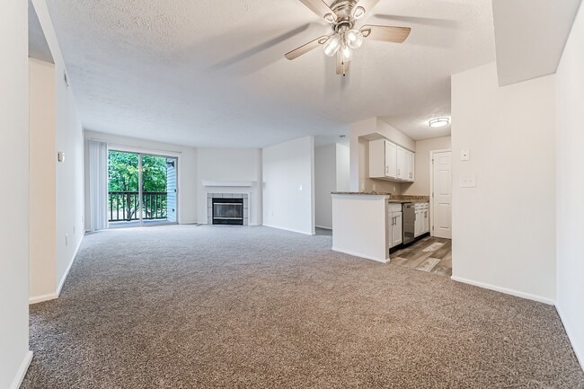 Carpeted living area with updated kitchen.
