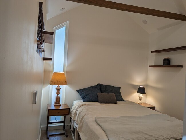 Bedroom furnished with dresser, bed with storage and hanging shelves. - 1330 Spruce St Unidad #A