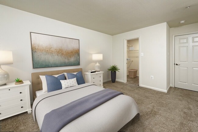 Bedroom with carpeted flooring and walk in closet