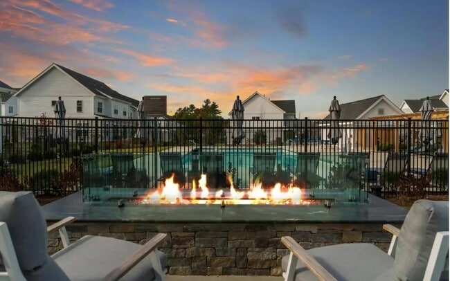 Evening Patio with Modern Fire Feature and Lounge Chairs - The Madison at Marshfield