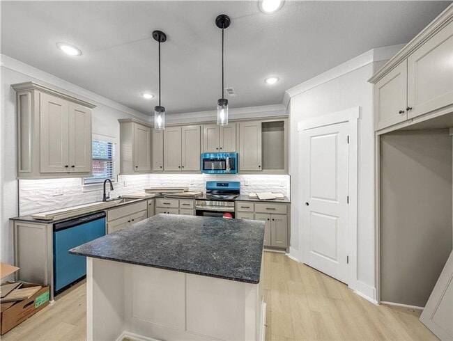 Photo - Modern open-concept living meets peaceful nature views in this custom-crafted retreat.