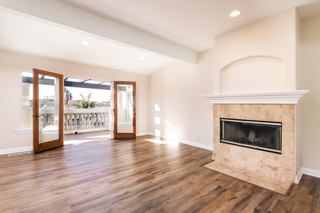 Living room fireplace and french doors that lead to the deck - 168 Ardmore Ave Townhome