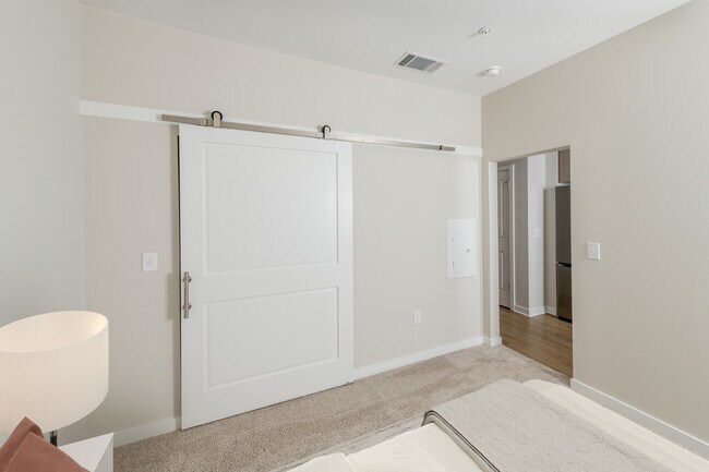 Studio bedroom with sliding barn door closet