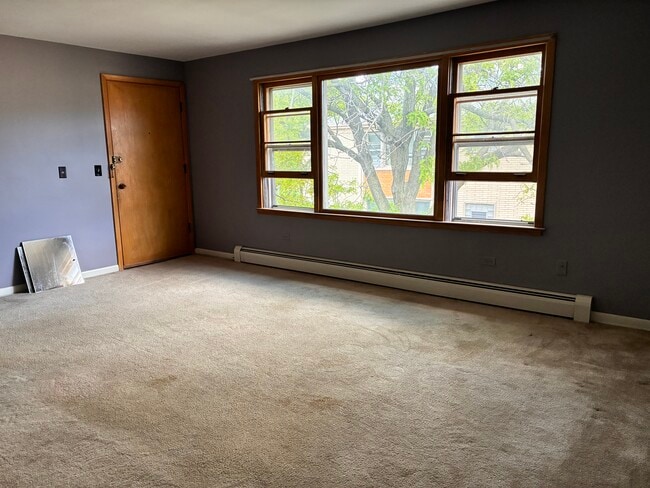 Large living room overlooking a beautifully landscaped courtyard. - 3515 S Harlem Ave Unit 6B