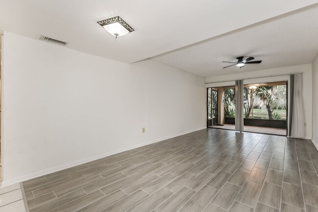 Photo - 3 BR / 2 BA Ground-Floor Condo | Screened Patio | Pool Access | Pet Friendly | $1,999/mo