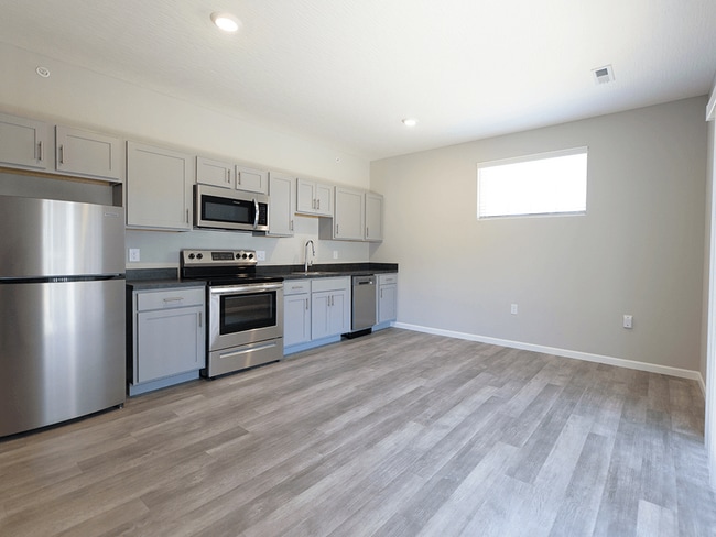 Shaker Cabinetry with Brushed Nickel Handle Pulls - The District at Ashland