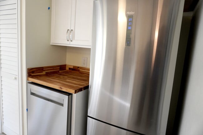 Sleek stainless fridge and dishwasher on wood counters, ready for Yankeetown's fresh catches. - 33 63rd St
