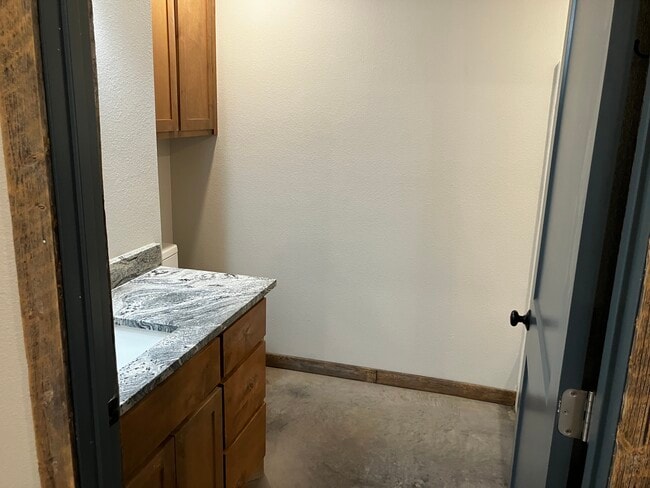 Bathroom with wood cabinetry and granite counter - 4392 Old Sadler Rd