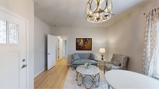 A living room stands in the center of the Efficiency suite, ready to be transformed - 15747 Ruthie Lynn Dr Unit B