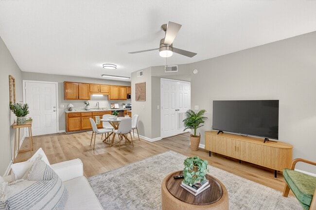 Open-concept living room with dining space at Saddlebrook Apartments