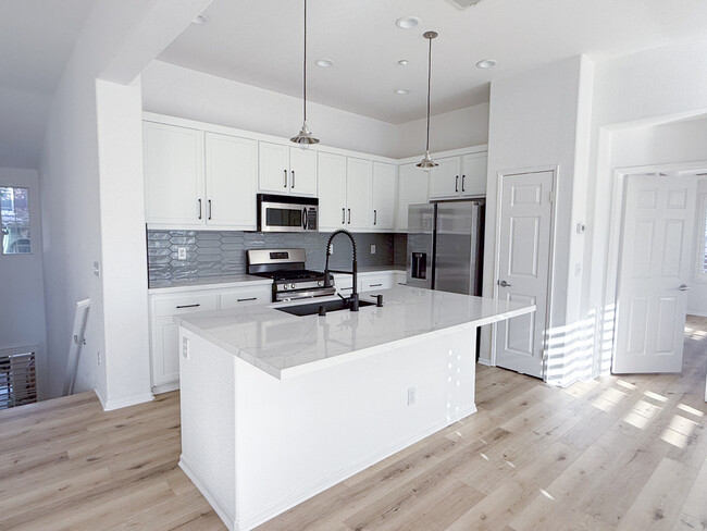 Kitchen with island - 1694 Avery Rd Townhome