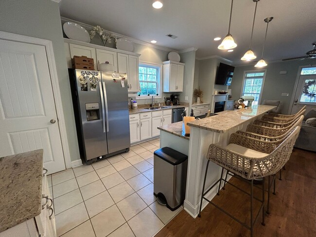 Photo - Enjoy private living in this beautiful 3 bedroom, 2.5 bathroom home on almost half acre lot!