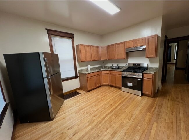 New kitchen with GRANITE TOPS newstainless steel appliances - 3748 W Lyndale St Unit 1st