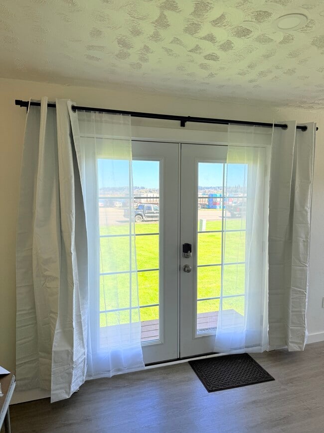 French door entrance with grass and river across the way - 103 A St Unit B