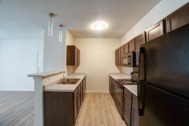 Kitchen with Breakfast Bar - Grand Station Apartment Homes