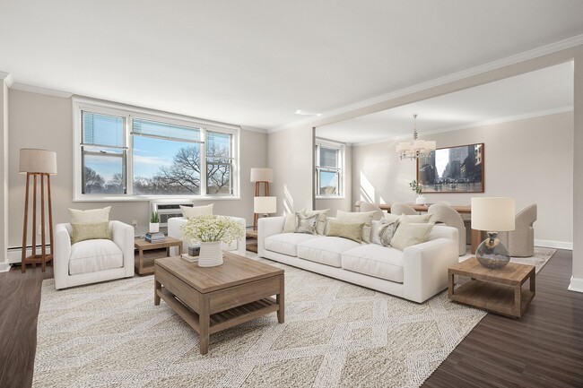 Inviting open-concept living and dining area with elegant decor, featuring large windows, plush seating, and abundant natural light at Parkside Place, apartments in Cambridge, MA