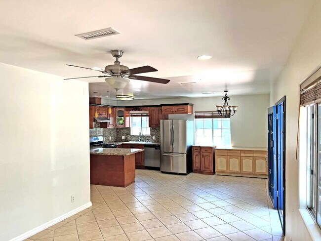 Living room looking back at kitchen, main entrance to the right. - 2330 S Mansfield Ave
