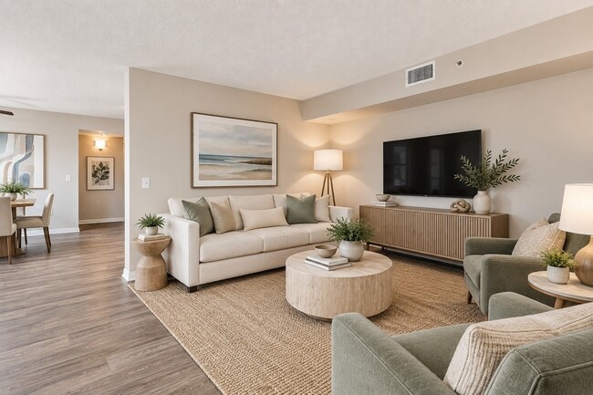 Elevate your living at Sanctuary Cove Apartments with this stylish, spacious living area featuring modern décor and cozy furnishings. This is the perfect space to relax or entertain. Schedule your tour today to see it in person!
